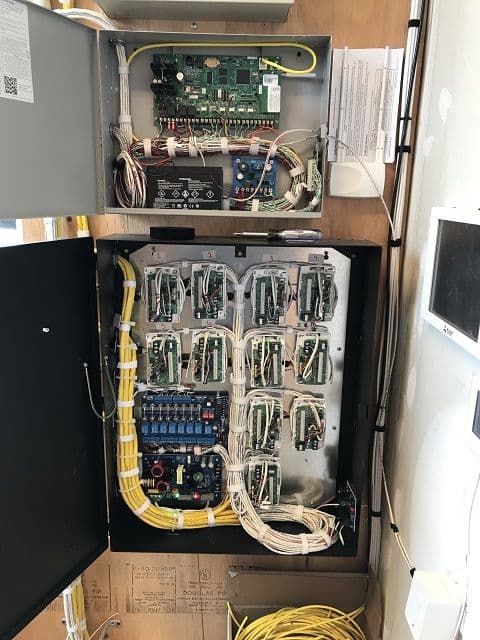 A DMP alarm panel and wiring in an equipment closet