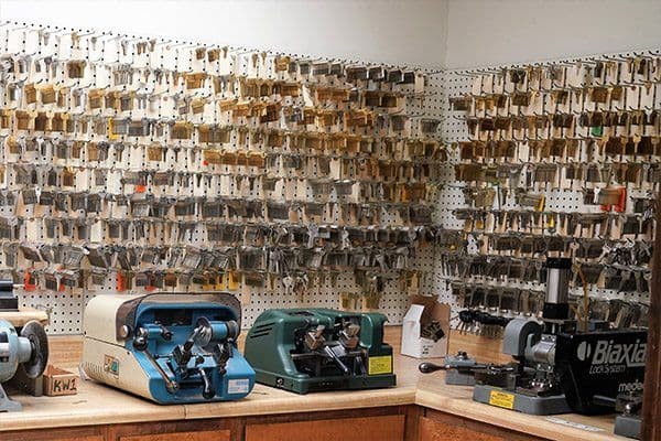Key cutting machines and a wall of key blanks