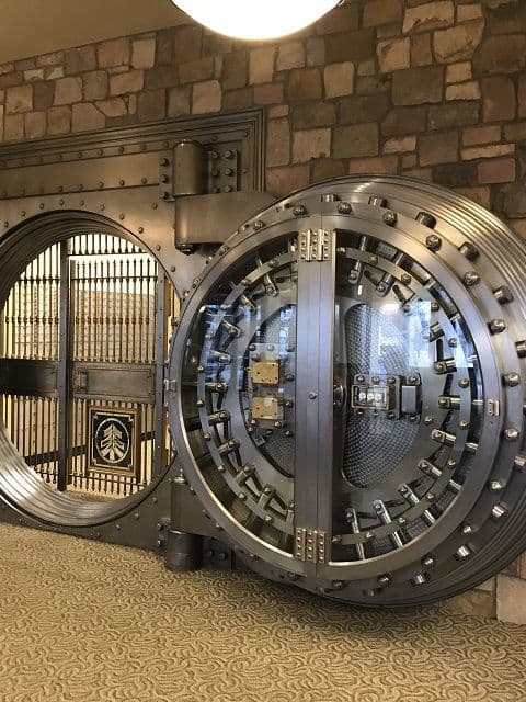 A round bank vault door, open